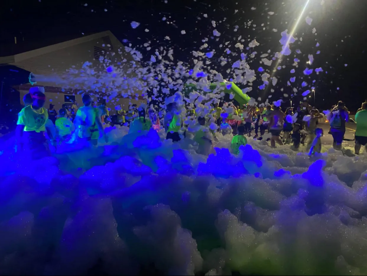 glow in the dark colorful foam at a night party